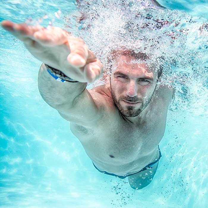 man swimming under water