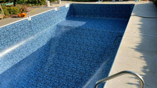 An empty pool with a blue LOOP-LOC pool liner is shown to illustrate the point that you should not drain your pool to prepare for an oncoming storm.